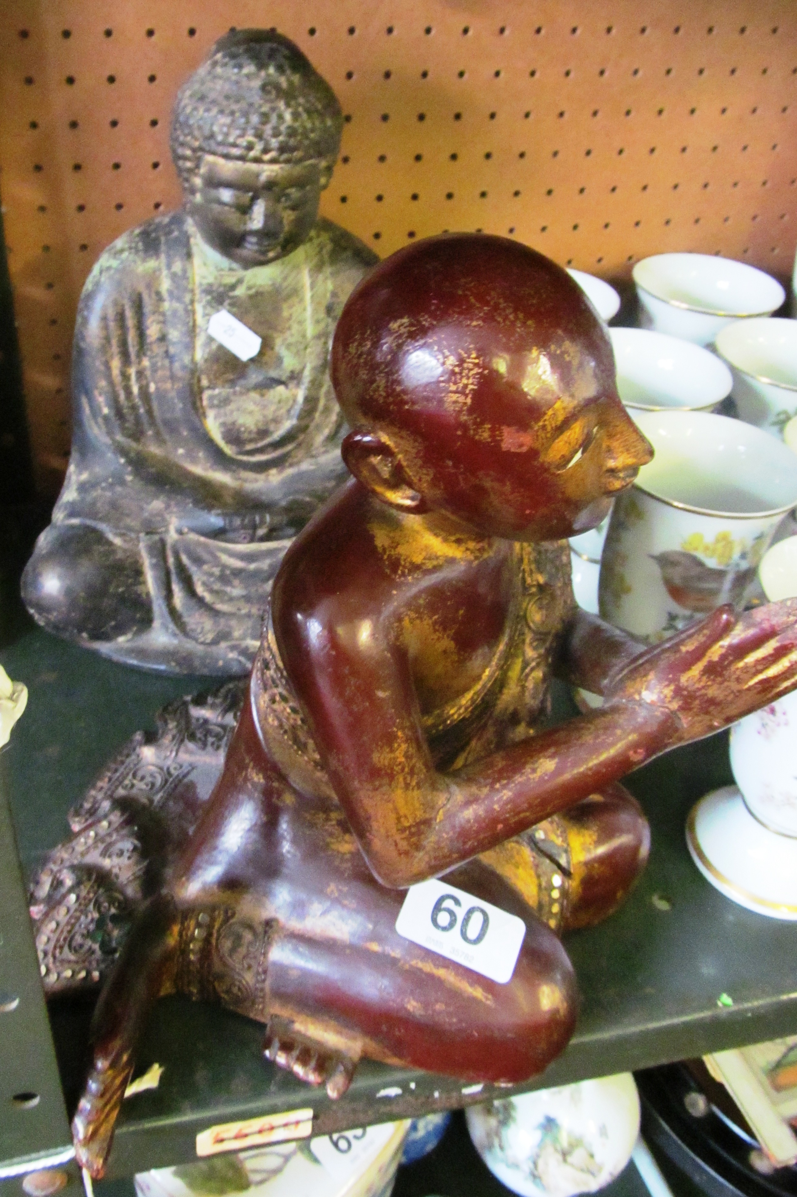 A bronze effect Buddha and a treen Thai figure praying with lacquer and gilt detail