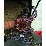 A carved treen elephant on stand and a bowl stand.