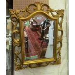 A gilt scroll bevelled frame mirror