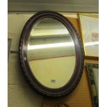 An oval mahogany mirror