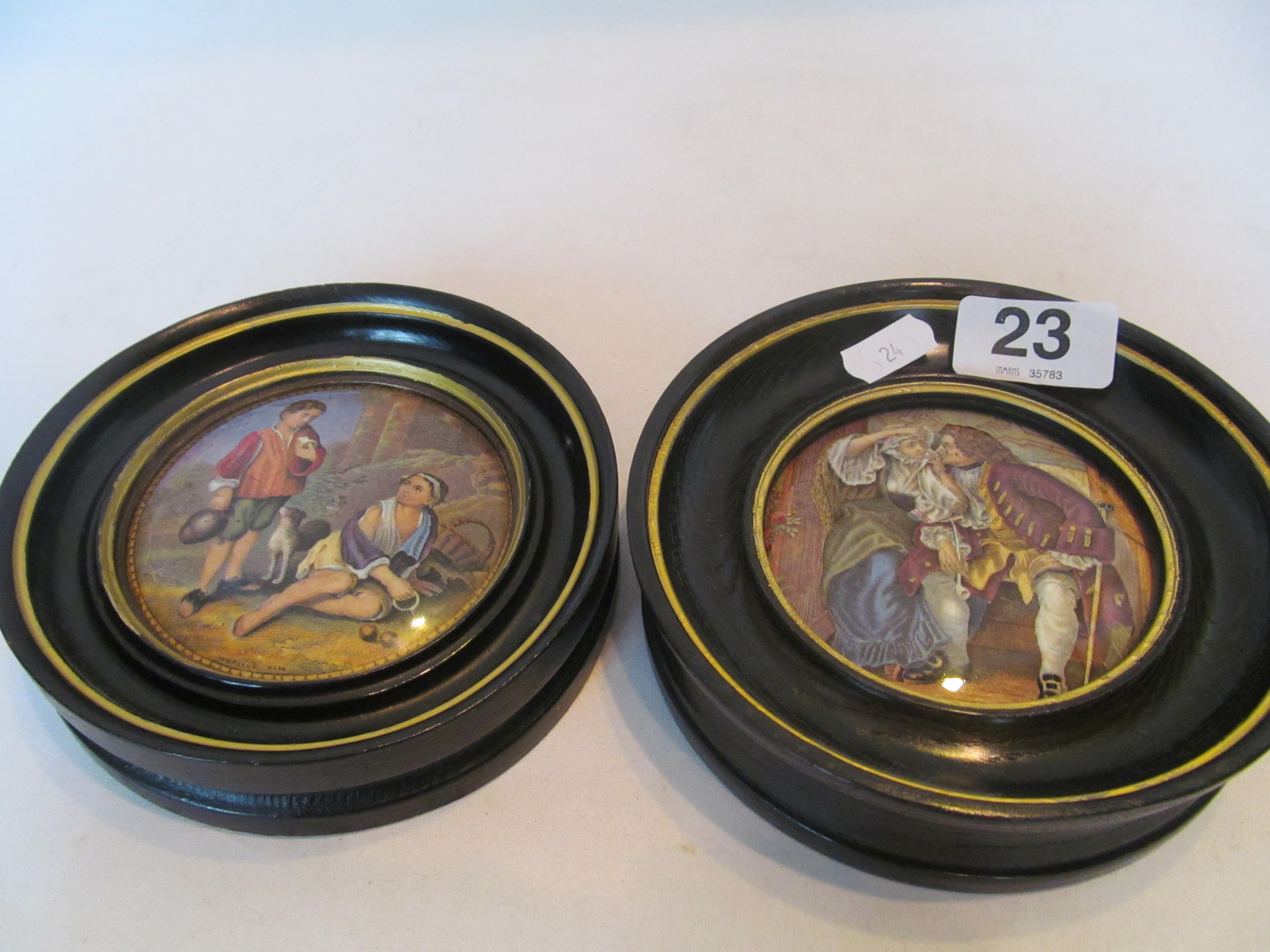 Two framed pot lids Hogarth style man and lady and another boy and girl with dog