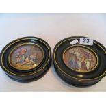 Two framed pot lids Hogarth style man and lady and another boy and girl with dog