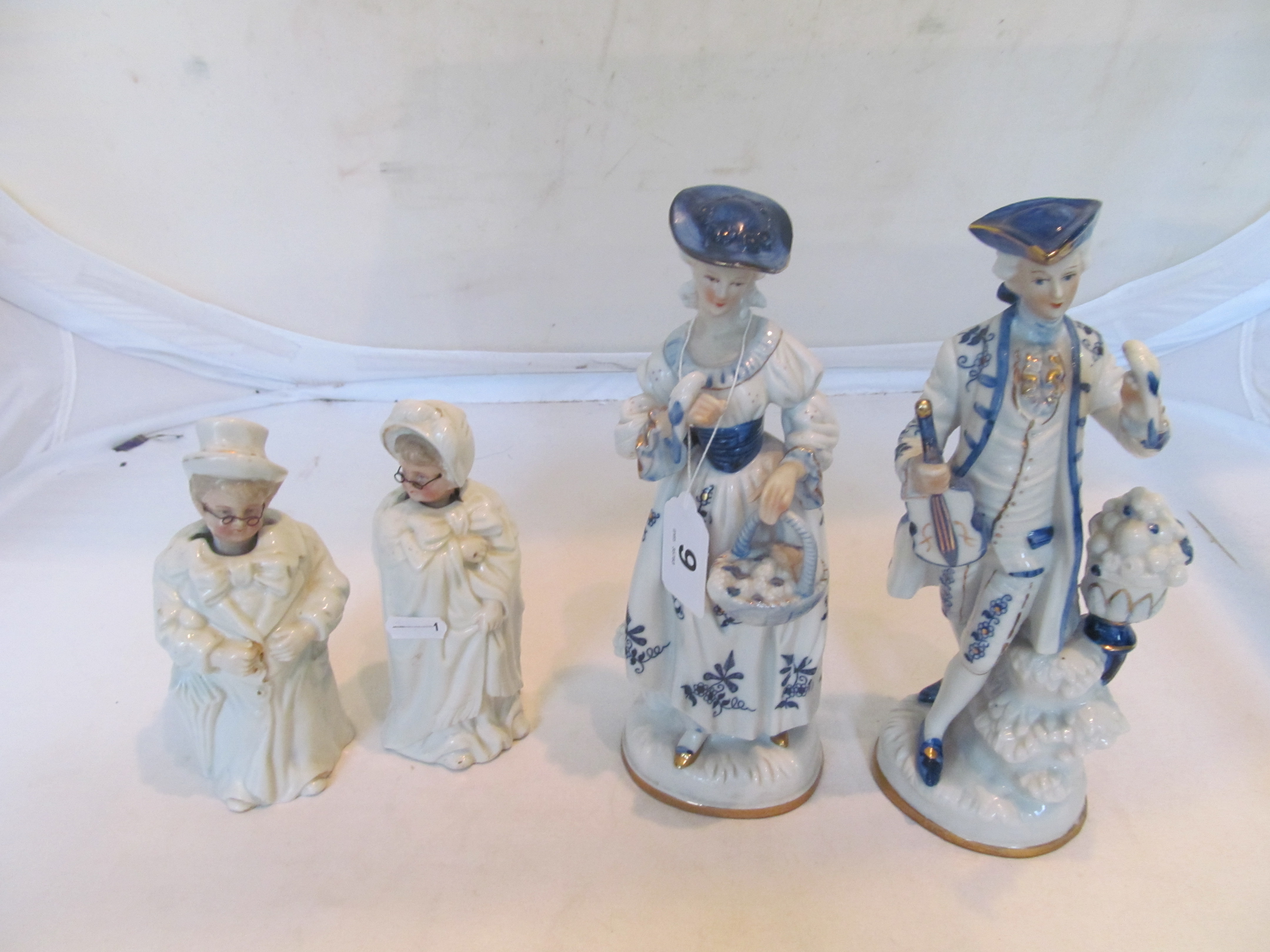 A pair of nodding head Victorian spectacled figures and pair blue and white figures