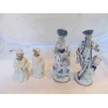 A pair of nodding head Victorian spectacled figures and pair blue and white figures