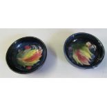 A pair of Moorcroft dishes.