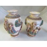 A pair of early 20th Century Satsuma style vases decorated riders and elephants.