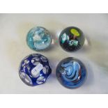 Eight blue glass paperweights.