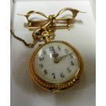 A fob watch on 15ct gold bow brooch