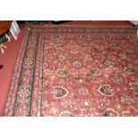A 340cm x 250cm Eastern carpet with red ground