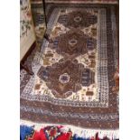 A 195cm x 112cm Middle Eastern rug with fawn ground