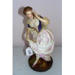 A late 19th century bisque porcelain figurine of a lady,