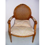 French Louis XIV, a reproduction Bergere arm chair, with a rattan back and lovely carving all round,