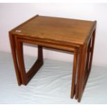 Retro teak, a nest of three tables in the G Plan style, the largest measuring 19.5" tall.