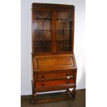 An early 20th century oak bureau bookcase. CONDITION REPORT: In good condition.