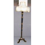 An early 20th century standard lamp hand painted in the chinoiserie style on tripod feet with an