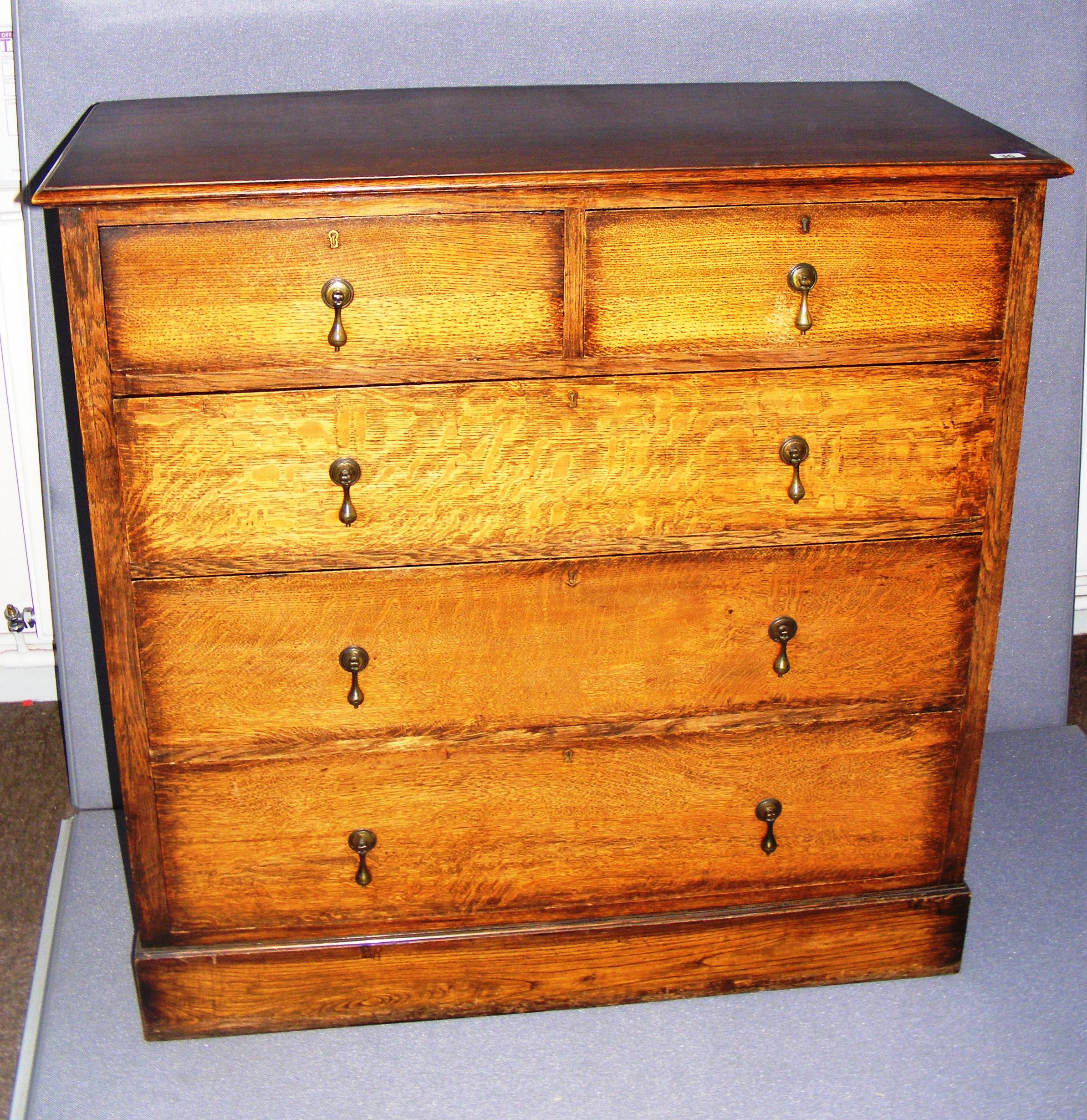 Victorian, a two over three chest of drawers, in solid oak with brass tear drop handles,