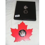 A 20 dollar 2015 Canadian maple leaf coin.