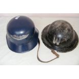 A World War II German military helmet and Air Wardens World War II helmet.