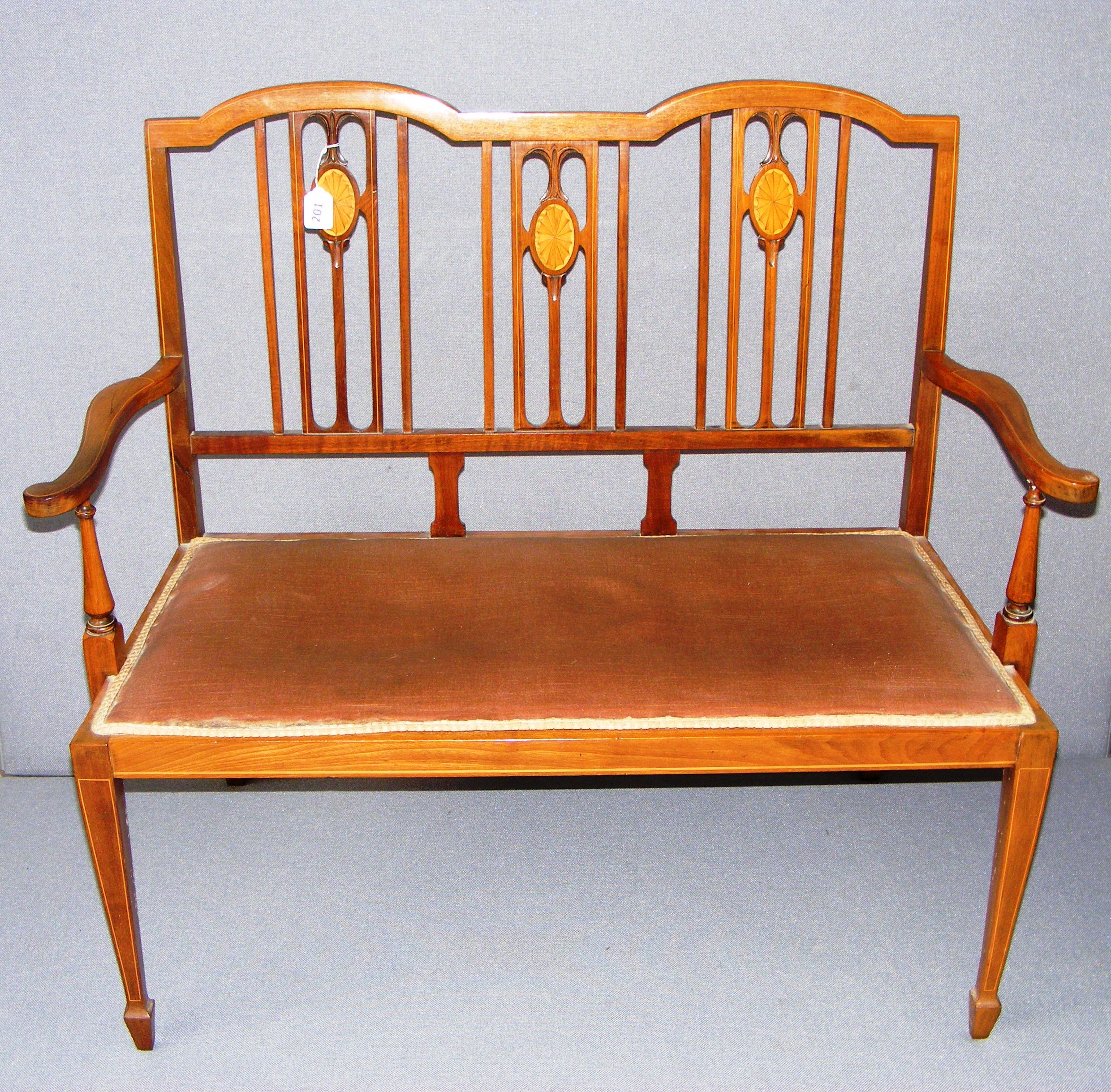 An Edwardian inlaid mahogany bench in good condition.