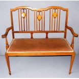 An Edwardian inlaid mahogany bench in good condition.