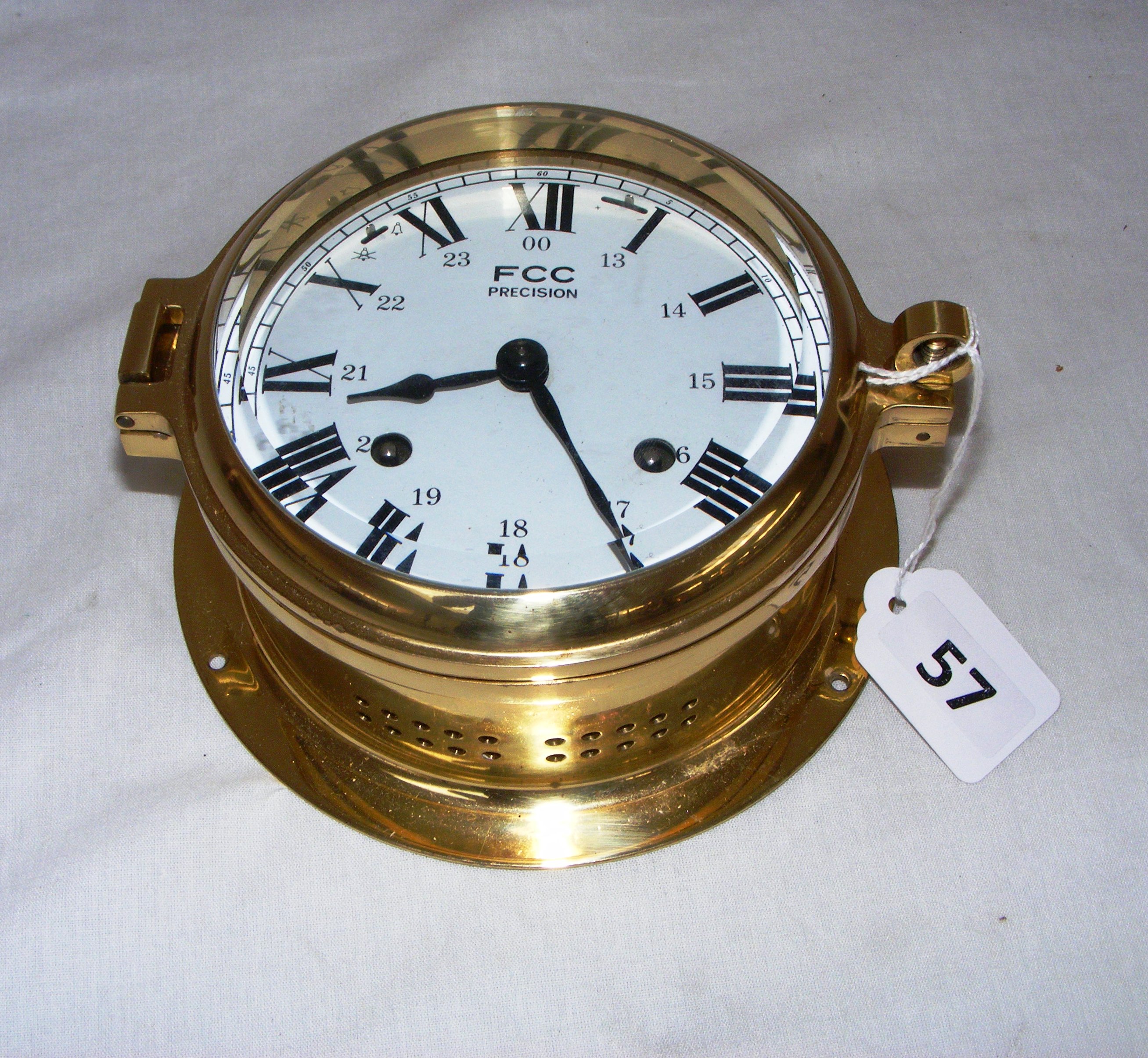 FCC Precision, a brass nautical wall clock measuring 6.5" in diameter.