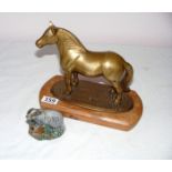 A cast metal horse on wooden plinth & a Beswick badger.