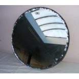 An Art Deco style circular glass mirror with a frilled bevel edge and clasps,