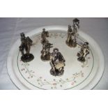 Six assorted metal figures, possibly silver plated, including a lamp lighter (5" tall).