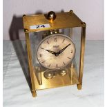 A Kundo Anniversary Clock with Kieninger & Oberdfell Movement, in a square glass case 6.75" tall.
