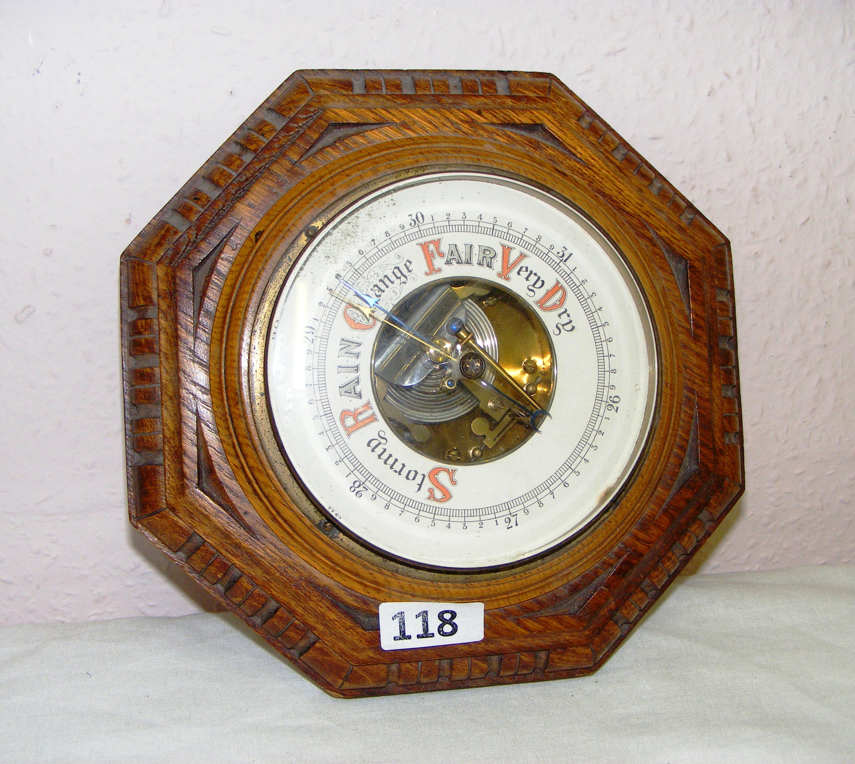 A mid 20th century circular oak wall barometer measuring 9" in diameter.