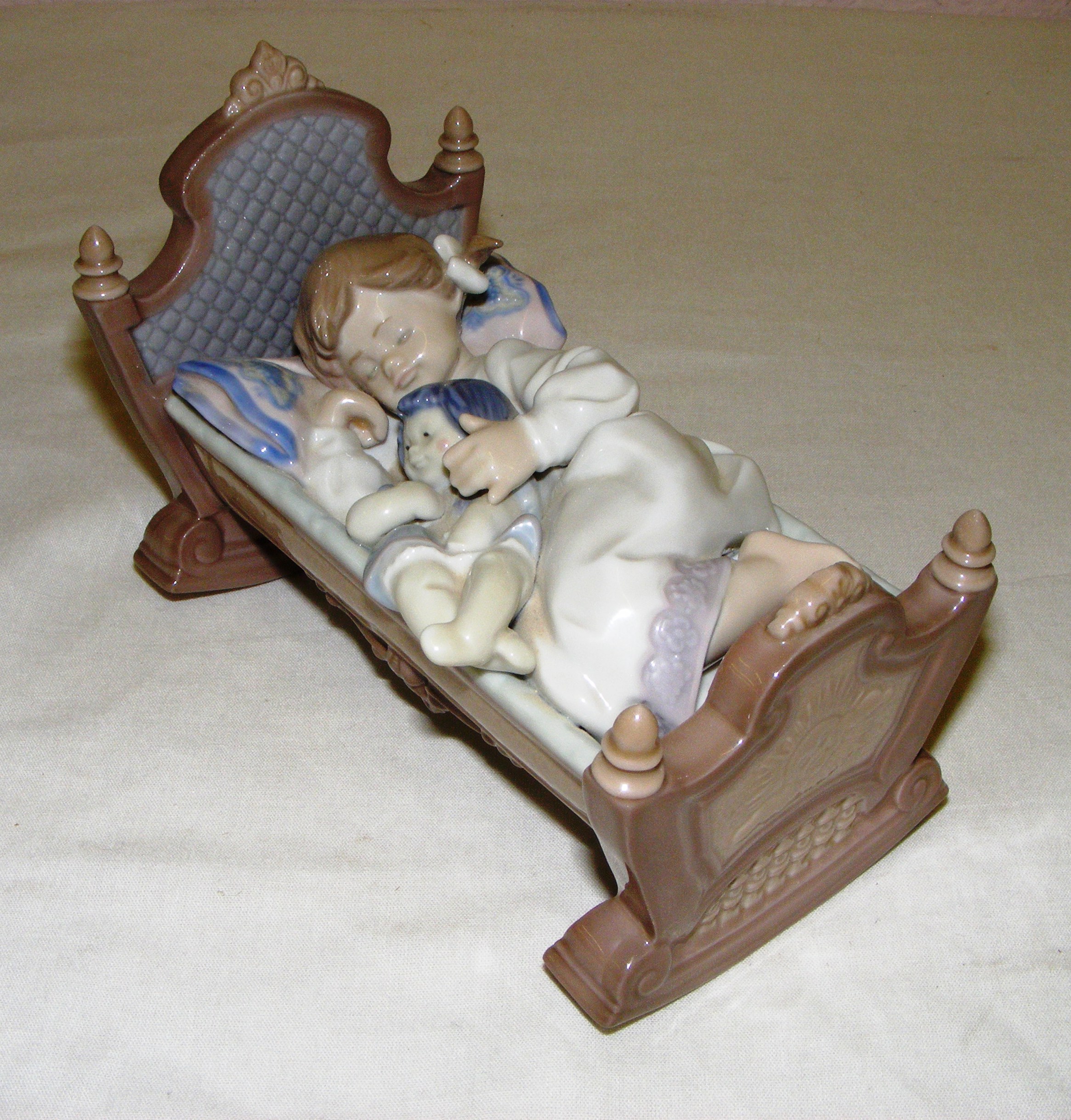 A Lladro figurine titled "Rock a bye baby", #5717, measuring 5" tall. Without original box.