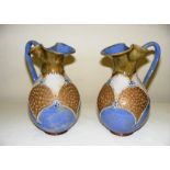 A pair of Royal Doulton pottery ewer jugs with lovely designs in the Art Nouveau style,