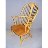 A mid 20th century blonde Ercol arm chair, labeled to the reverse and measuring 23" wide.