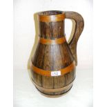 A Georgian style oak and copper bound ale jug, marked to the top V-Radford Maker,