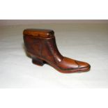 A mid Victorian treen snuff box made in the form of a boot, measuring 2" tall.