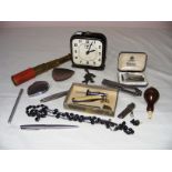 A vintage American Hustler alarm clock, a miniature telescope, pen knives, lighter etc.