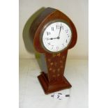 An Edwardian mahogany inlaid tulip mantle clock on four bun feet,