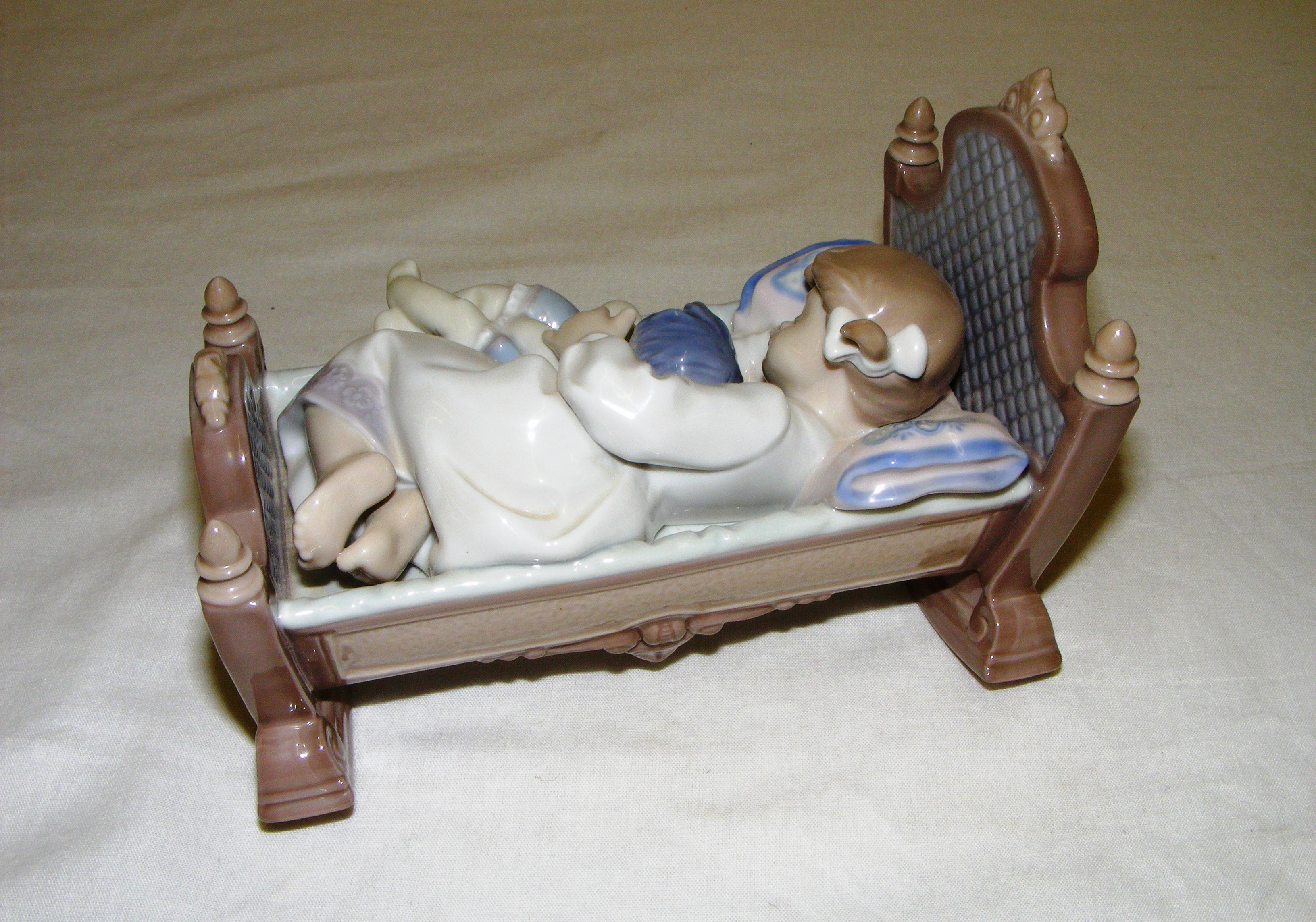 A Lladro figurine titled "Rock a bye baby", #5717, measuring 5" tall. Without original box. - Image 2 of 3
