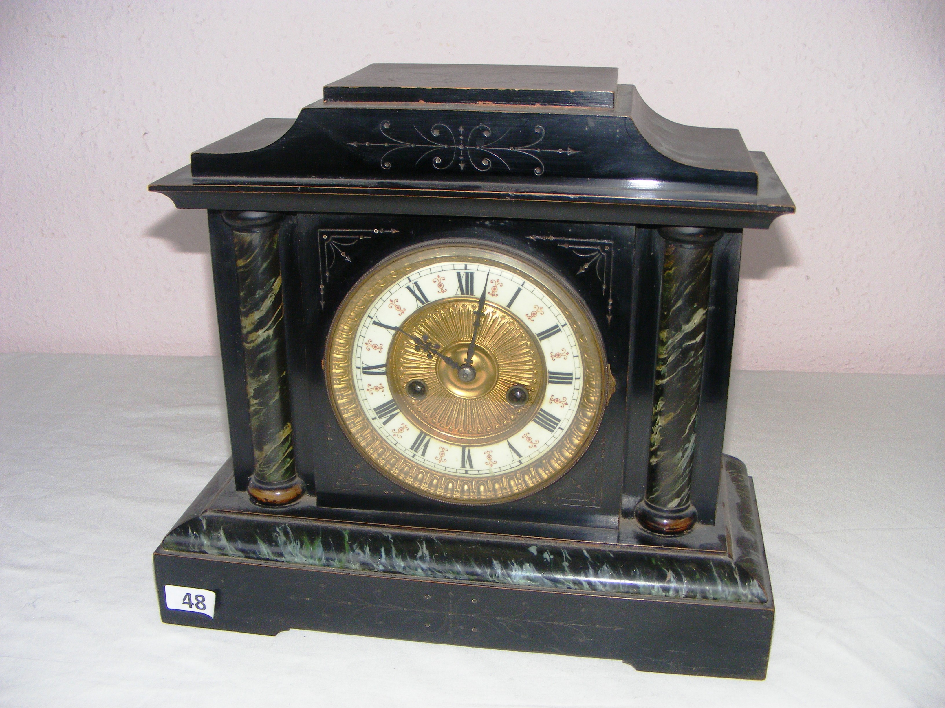 A Hamburg America 14 day mantle clock, made from wood in the marble effect, with a decorative dial,