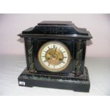 A Hamburg America 14 day mantle clock, made from wood in the marble effect, with a decorative dial,