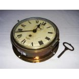 An antique Smiths Empire ships clock, in good working order with its original key, measuring 7.