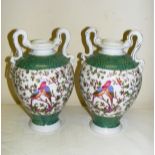 A pair of continental twin handled porcelain vases, painted with birds and scales,