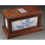 AN ITALIAN CARVED WALNUT AND MAJOLICA CASKET