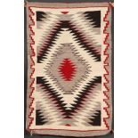 A SOUTHWEST NAVAJO “EYE DAZZLER” HANDWOVEN RUG