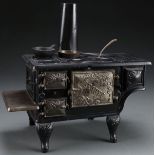 A CHILD'S CAST IRON TOY “BEAUTY” COOK STOVE