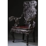 A JAPANESE CARVED EBONIZED WOOD DRAGON ARMCHAIR