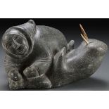 A SOAPSTONE CARVED INUIT FIGURE WITH WALRUS