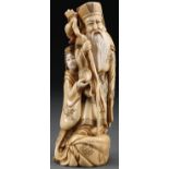 A JAPANESE CARVED IVORY OKIMONO OF AN IMMORTAL, M