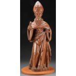 A CARVED WOOD FIGURE OF A BISHOP SAINT