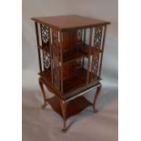 An Edwardian Mahogany Satinwood Crossbanded Revolving Bookcase with shaped under tier,